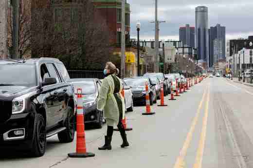 A Wayne State medical professional particiaptes in the Detroit Regional COVID-19 Drive Thru Testing Program as she prescreens a first responder Friday, March, 20, 2020 before they are tested for COVID-19. Wayne State with the help of the DPD funneled traffic one way down Brush Street from the I-75 service drive to tents set up in a lot at 2900 Brush Street in Detroit.
