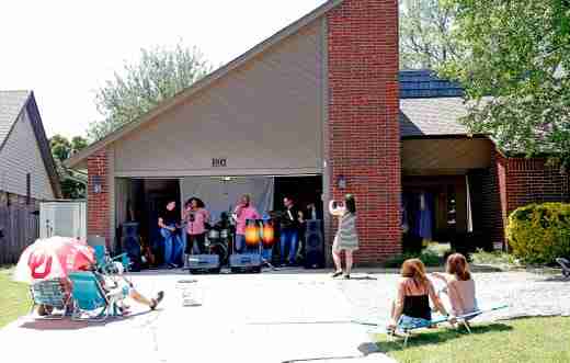 The band Hypnotik performs out of a garage in a Northwest Oklahoma City neighborhood, for a social distance concert for neighbors, Saturday, May 2, 2020. 