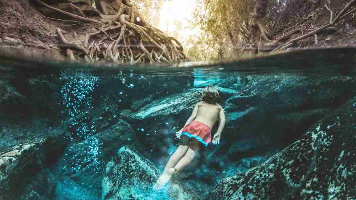 Child swimming in the woods