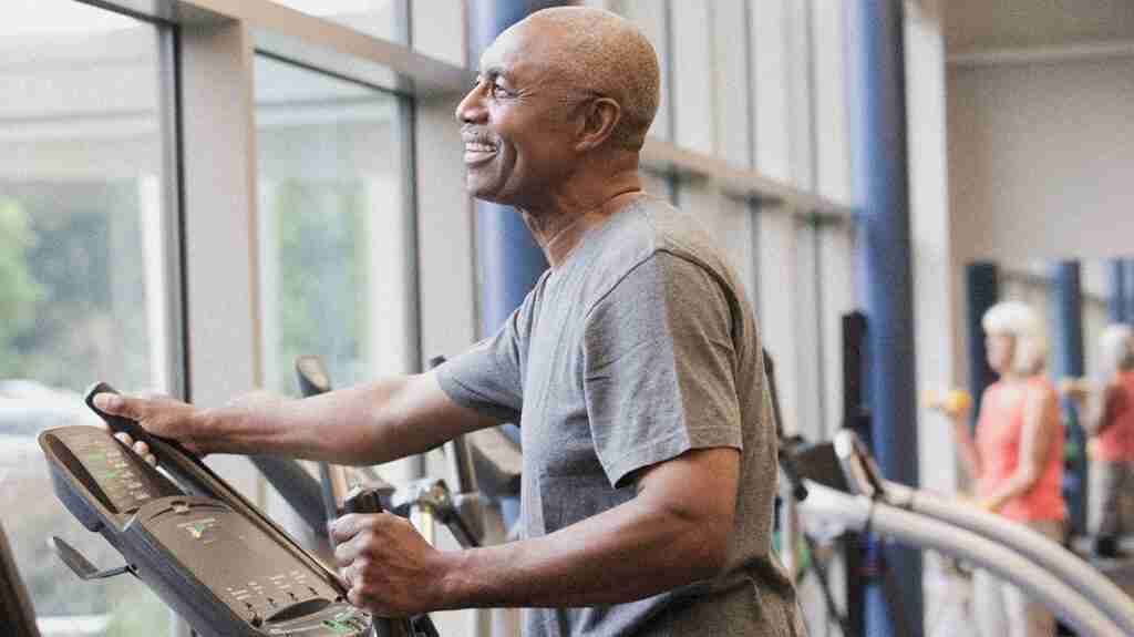 A male senior exercises on an elliptical to accompany the article Immune aging and how to combat it.